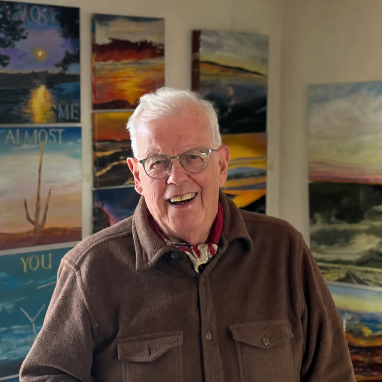 Ralph Reed in his studio in front of his paintings